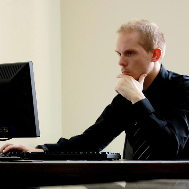 Man looking puzzled at computer