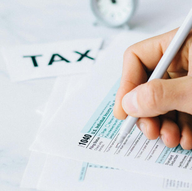 Person filling out tax forms